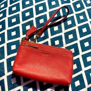 Used once melon/coral color mini double zip wristlet but in good condition